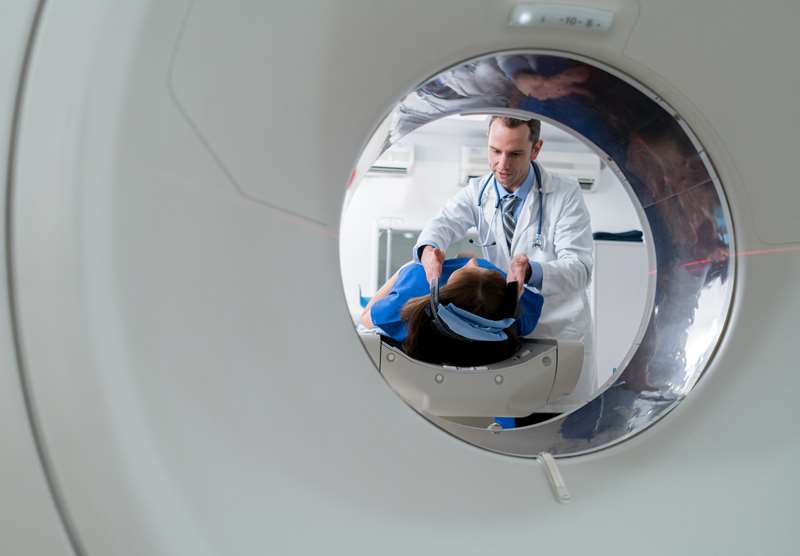 Médico realizando tomografia em paciente 