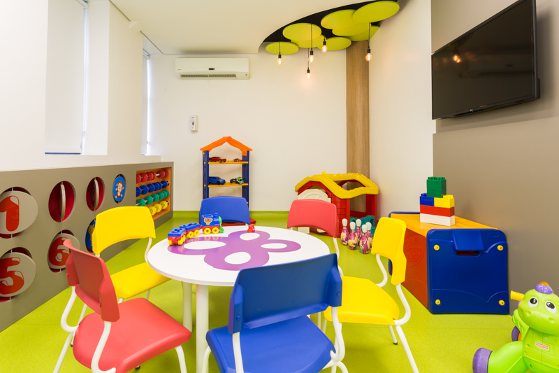 Brinquedoteca do Hospital BP, com mesa, cadeiras e diversos brinquedos coloridos à disposição dos clientes pediátricos.