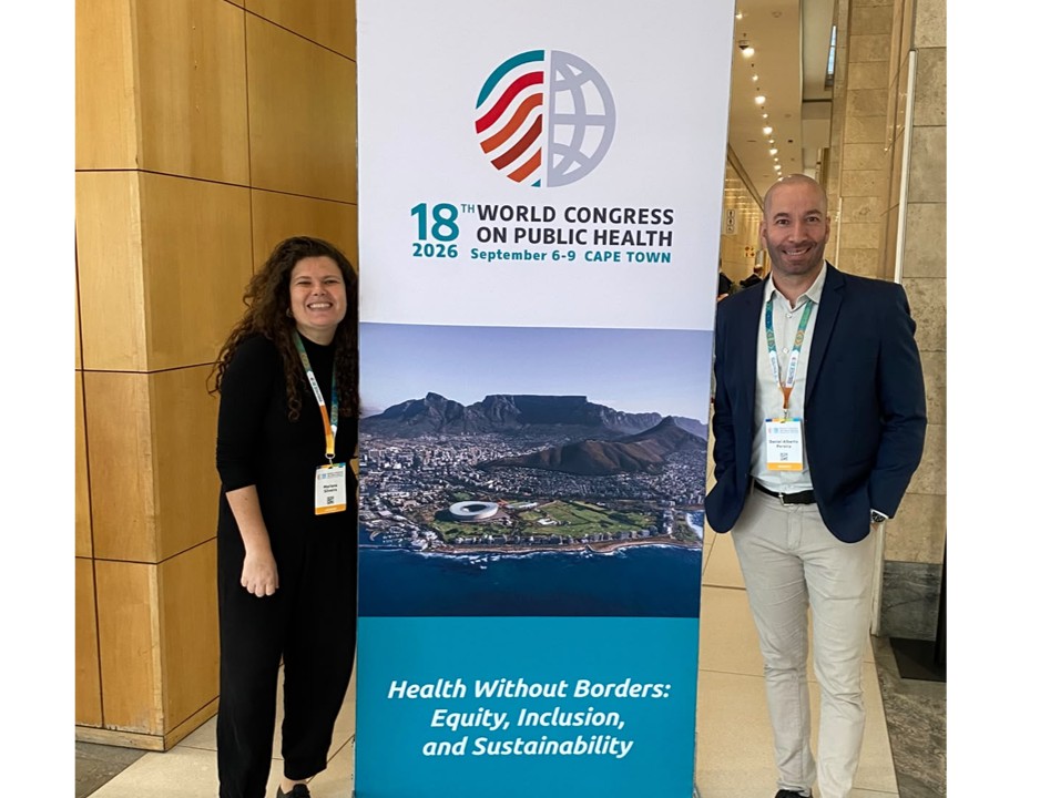 Duas pessoas posam ao lado do painel do 18º Congresso Mundial de Saúde Pública 2026, realizado na Cidade do Cabo, África do Sul.